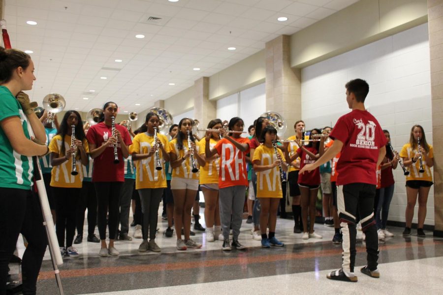  Marching band performs as students enter the gym for the homecoming pep rally last Friday. The band performed again during the pep rally with color guard. “I wasn’t as nervous because I felt like they would support me no matter what; it was a lot of fun,”  freshman Abhishek Sharma said.
