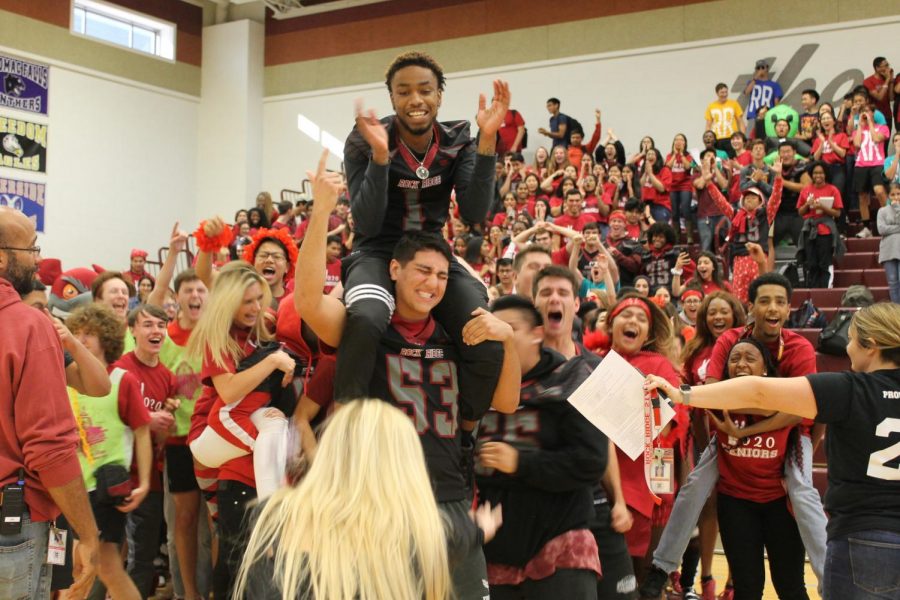 Seniors Darius Mayo and Samal Khosravi cheer with their class at the Homecoming pep rally on October 11. The two varsity football players expressed their excitement for the game along with the rest of the senior class to win the spirit stick.