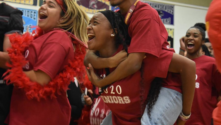 Senior+Kayla+Davis+screams+with+senior+Jordan+Cox+on+her+back+during+the+pep+rally.+Davis+was+participating+with+other+seniors+in+the+class+cheer+of+the+pep+rally.