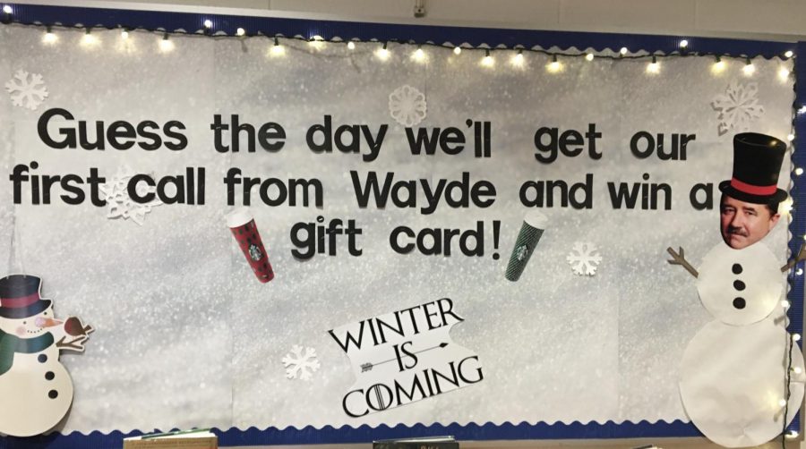 “Guess the day we’ll get our first call from Wayde and win a gift card!” a sign reads, decked out with a Wayde-faced snowman and lights in the RRHS library. In front of the sign sits the box for students to place their guesses for the ‘Game of Phones.’