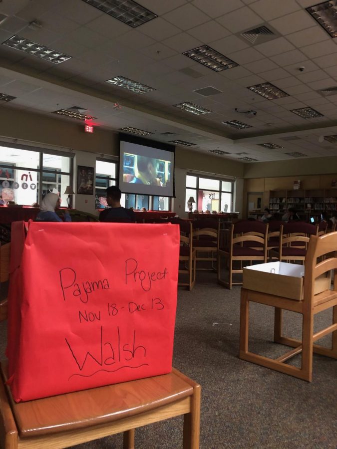 Friends and family gather in the library to participate in the NEHS movie night. 