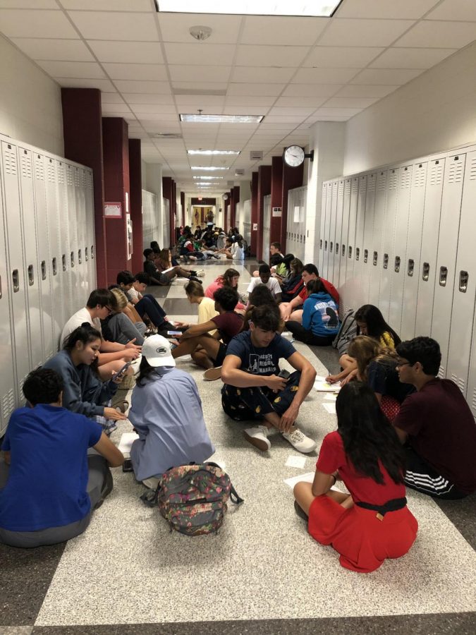 WINGS mentors and freshman students gather around in the hallways discussing their personal and educational interests. 