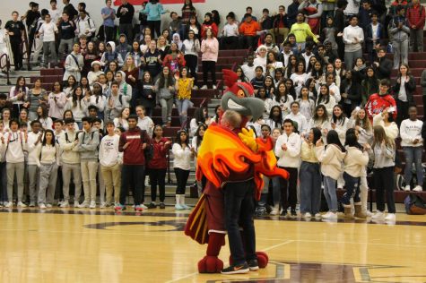 Rocky and former physics teacher Myron Hanke spread the holiday cheer as they share a hug during Hanke’s lip-sync performance. The students were on their feet as he continued to saunter around the gym to the beat of the song.