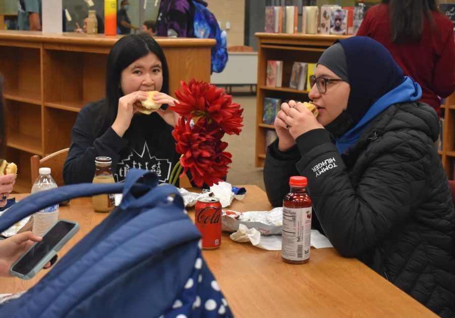 Seniors Esther McPalmer and Maryam Nabih eat Chick-fil-A breakfast sandwiches in the library during senior breakfast. “[Senior year] is going OK, it’s not bad, and I’m enjoying early release and [taking] less classes,” McPalmer said. McPalmer looks forward to prom and future senior breakfasts during her last year of high school.
