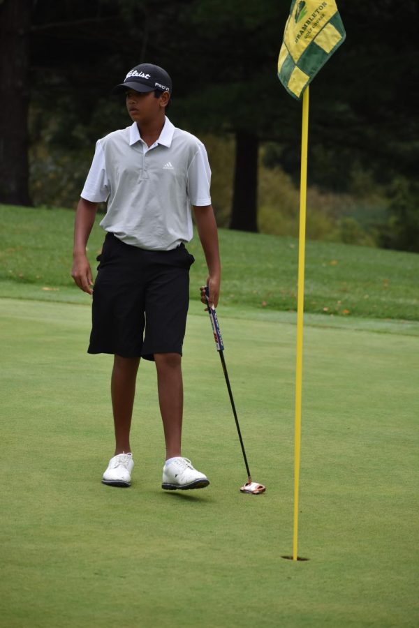 Aiden Patel walks towards the golf hole to line up his next shot at the Brambleton Golf Course during the District Tournament.
