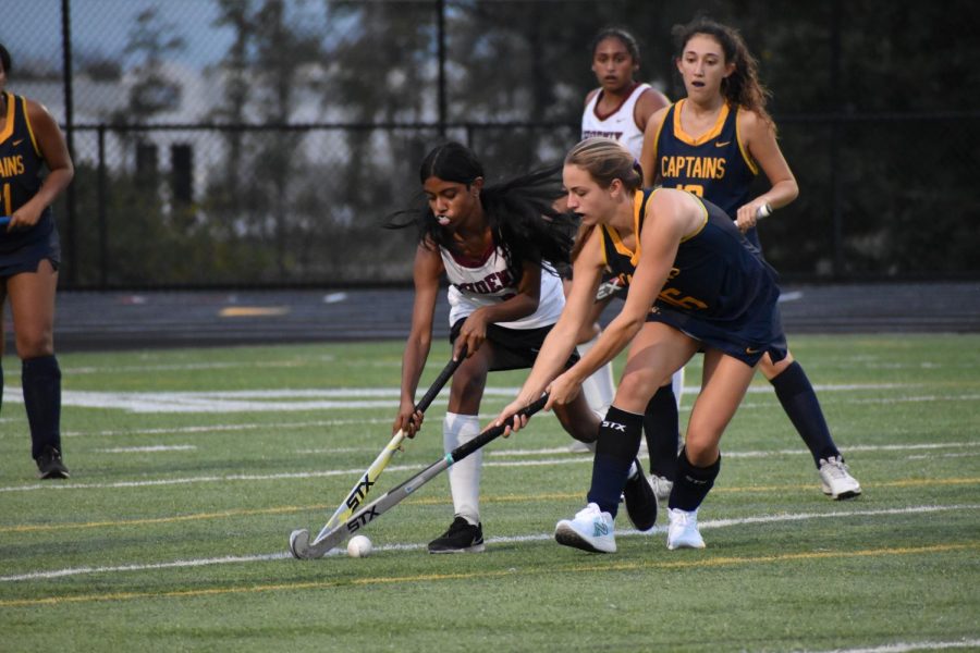 Freshman+Saihaj+Kaur+and+junior+Deeksha+Borra+clash+with+the+Captains+in+an+attempt+to+score+a+goal.+A+few+moments+after+the+attempt%2C+Kaur+suffered+an+injury+to+her+ankle+and+toe.+%E2%80%9CWhen+I+first+joined%2C+I+was+like+%E2%80%98oh+my+God%2C+I+can%E2%80%99t+do+this%2C%E2%80%99+but+now%2C+it+might+be+a+little+hard%2C+but+I+can+do+it%2C%E2%80%9D+Kaur+said.+