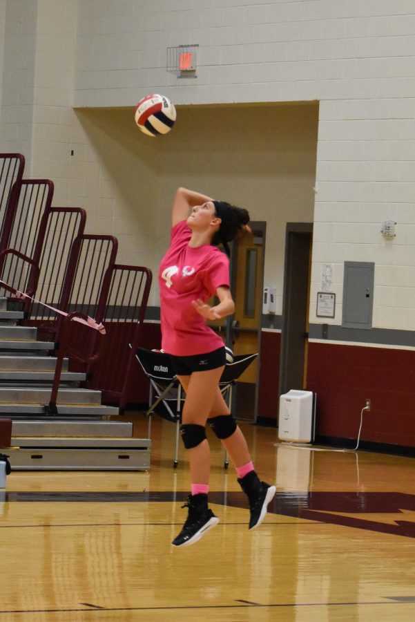 Poised for the perfect strike, sophomore Grace Tucker aims to score. Tucker was a team star in the first set, scoring multiple set winning strikes. “I’m really glad we won the game because it was our Dig Pink game and we all came together as a team and played well,” Tucker said.