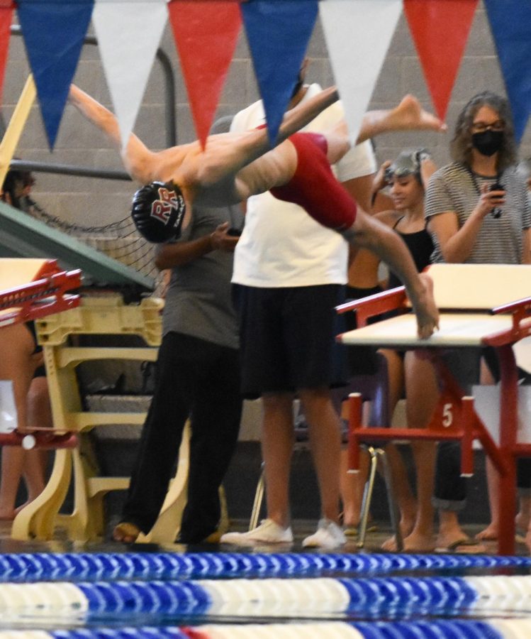 Freshman Andrew Takach dives in for his 200 yard IM race. “I love the competition and team environment. I enjoy improving and working hard,” Takach said. While this is Takach’s first year on the team, he has been swimming competitively for 8 years prior to joining.