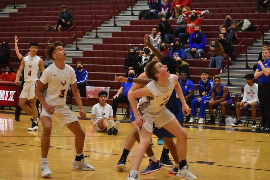During an intense fourth quarter, the rest of the Phoenix eagerly waited for the opportunity to rebound after a shot from senior Aditya Kamath (5). 