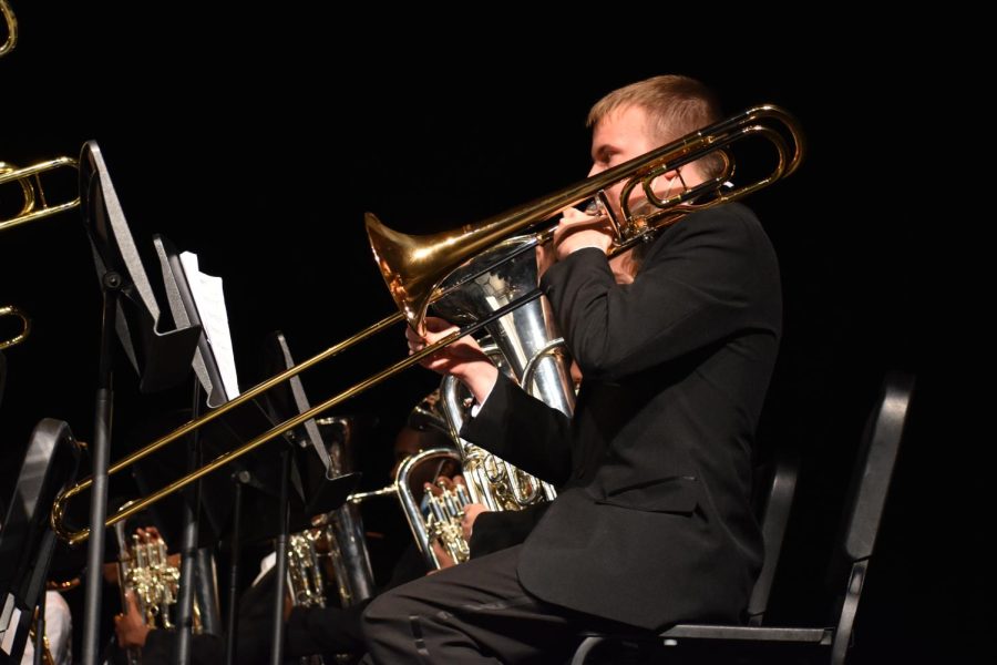 Trombone player senior Tj Lynch performs during the first half of the concert.
