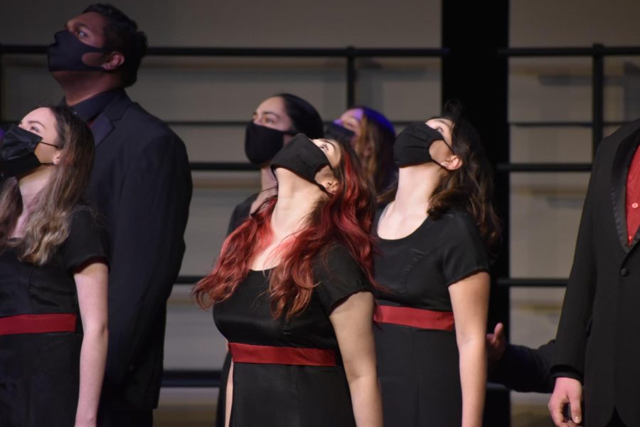 Shining under the spotlight, the Chamber Choir performs a thoroughly choreographed number at the Dec. 9 choir concert.