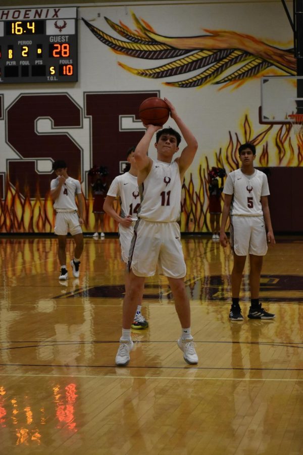 Senior Brett Suazo (11) shoots a free throw seconds before halftime. Suazo made both free throws to tie the game.