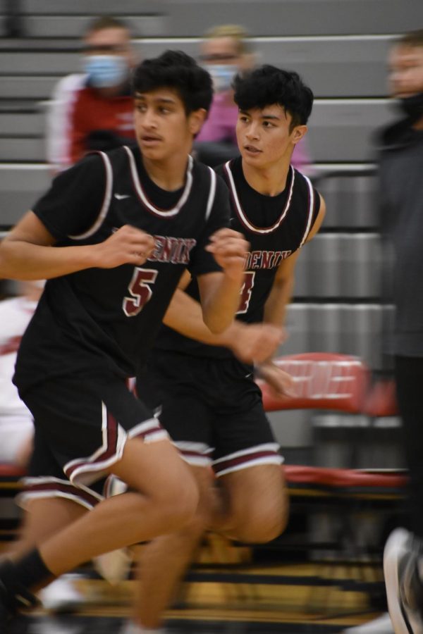 Senior Aditya Kamath and junior Basit Qadri run in sync as they get back to defend their basket against the Lions.