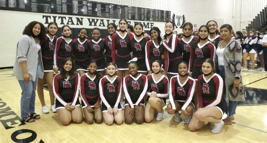 Coach Cortnee Williams (left) poses with the cheer team.