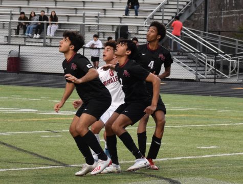 Seniors Shahaan Bashir (8), Varun Reddy (2), and Hamza Hirad (4) prepare to head the ball from a cross into the box during the first half.