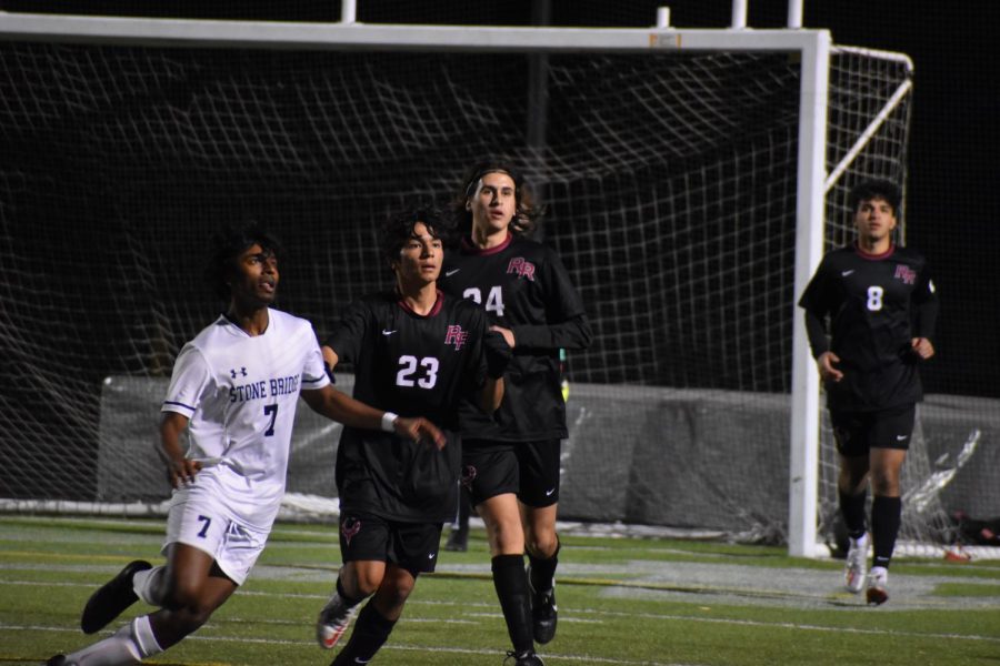 With their gaze fixed on the ball, freshman Rishit Choudhari (23) and senior Mo Hammadi (24) run towards the action.