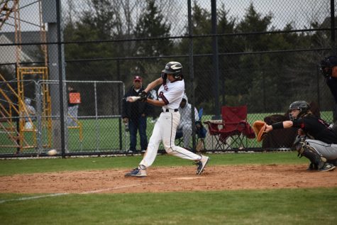 Freshman Dhruv Vemuri (8) bats for the Phoenix, hitting the ball before running to first base. “One thing that Id like to improve on is being able to hit off of the better pitchers,” Vemuri said. “We’re going to keep facing good pitchers and I want to be able to hit off of them.”