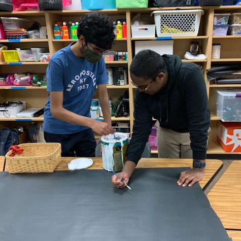 Senior and SCA executive treasurer Ethan Devarapalli and sophomore class class president Jag Maddipatla work on a poster for prom in the SCA room.