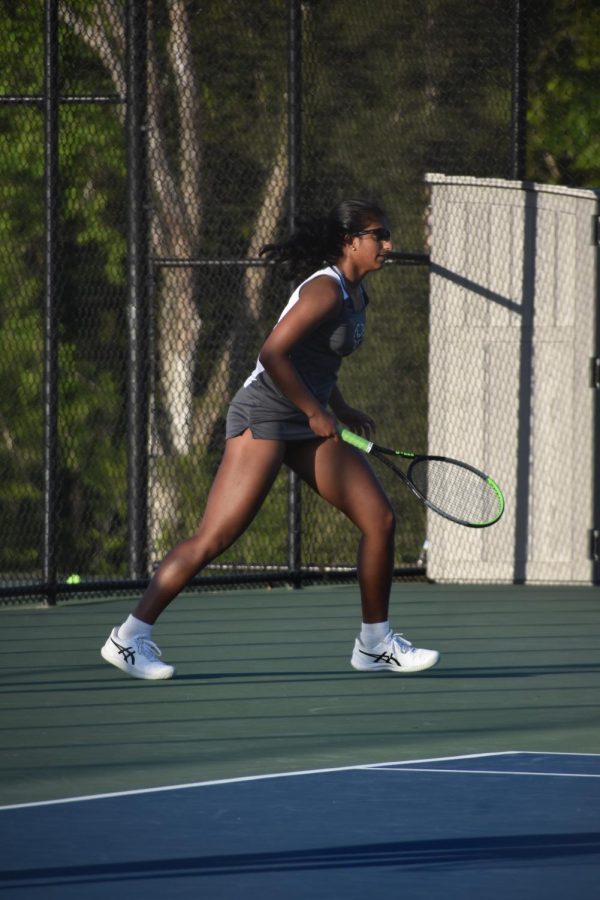 Senior Anya Ambarish waits for her opponent to return the ball during her doubles match. Ambarish is the captain of the team this year and plans to continue playing club tennis at the University of Central Florida next year. “I might even walk on to their Varsity team,” Ambarish said.