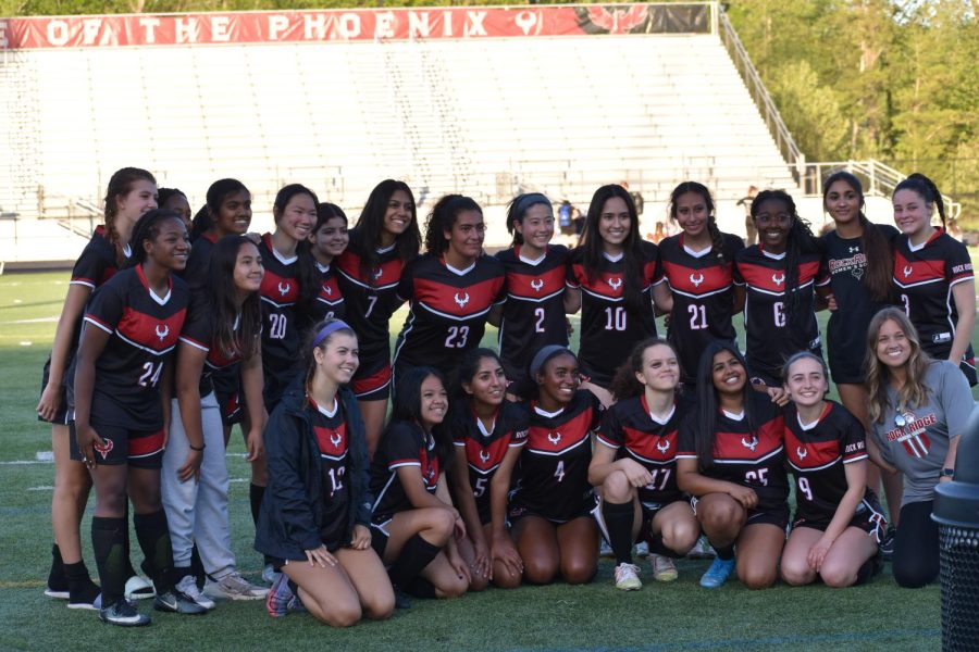 The girls varsity soccer team comes together for a team photograph at the last home game of the season. The seniors finished off their senior night with a leading score of 8-0.