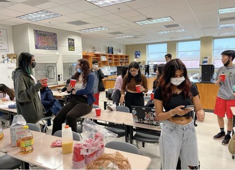 Holding a cup filled with the meeting’s mystery juice, Juice Club members gathered on April 6 before school in science teacher Michael Clear’s room to try new juices, mingle, and eat snacks.