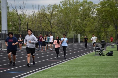 The track and field team warms up together with laps at practice after school.