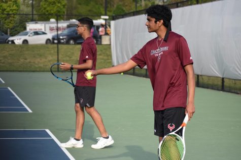 Senior Anish Nandyala prepares to serve during the doubles matches, with partner sophomore Aryan Dhiman ready to play.