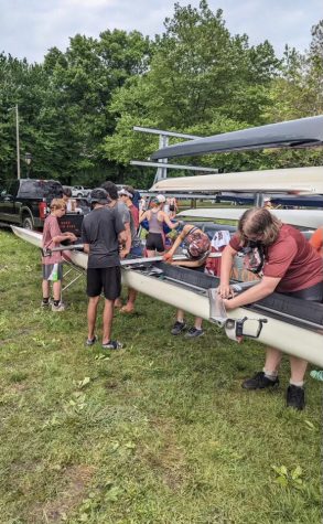 Members of the Phoenix crew team work on their boats during the Stotesbury Cup Regatta.