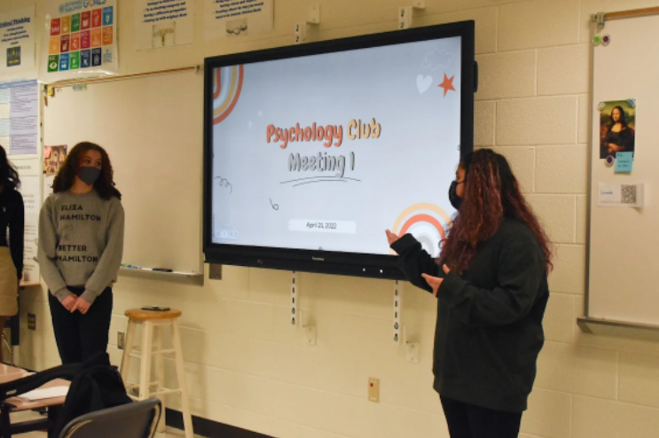 On April 21 at the second Psychology Club meeting, freshmen co-presidents Lauren Madison and Natalie Martinez discuss writing positive affirmations on sticky-notes to display in the hallway.