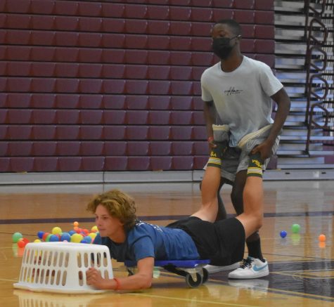 After volunteering to participate in the “Hungry Hungry Hippos” inspired pep rally game, freshmen Conner Bultema and David Lassissi attempt to collect the most balls in their laundry basket while competing against four other duos.