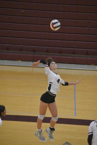 Eyes fixed on the ball, left side hitter junior Grace Tucker gets ready to spike the ball to the opposing team.