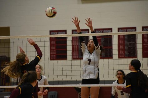 Junior Michelle Kim (7) jumps up to block an incoming spike from a Spartan player.