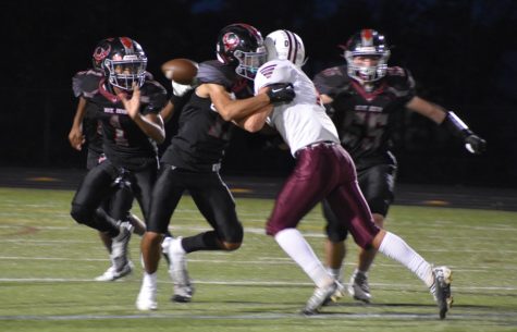Senior Basit Qadri (11) tackles the Railroader opponent while sophomore DJ Harvey (10) runs to catch the ball.
