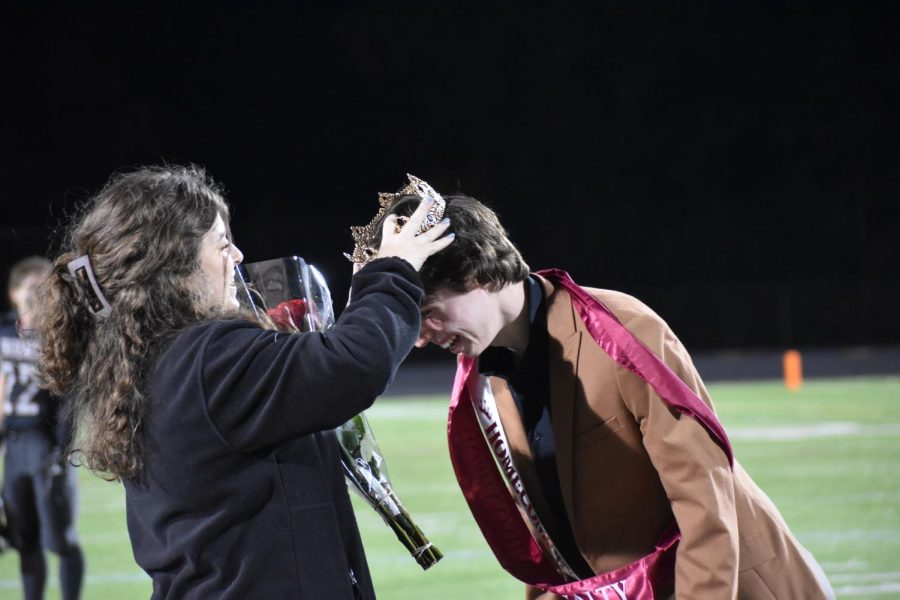 During halftime of the homecoming football game, senior Jack Capobianco wins homecoming royalty and is officially crowned by junior Maggie Miller. “I wasn’t expecting [winning homecoming royalty] at all,” Capobianco said. “I was very surprised but very excited.”