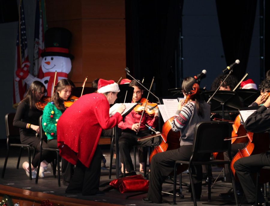 Orchestra Director Teresa Gordon directs the musicians to play softly while conducting the third piece of the winter concert, “Holiday Salute,” arranged by James “Red” McLeod. 