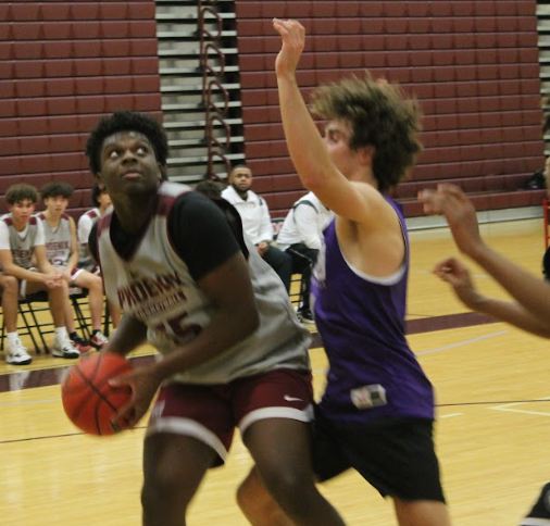 On the right, junior Daniel Okoye (55) observes the free throw. Okoye stood at the side, getting ready to intercept the rebound in case the free throw was missed. “A lot of embarrassing moments happened in the game,” Okoye said. “But I think we stayed mentally strong and kept going.”