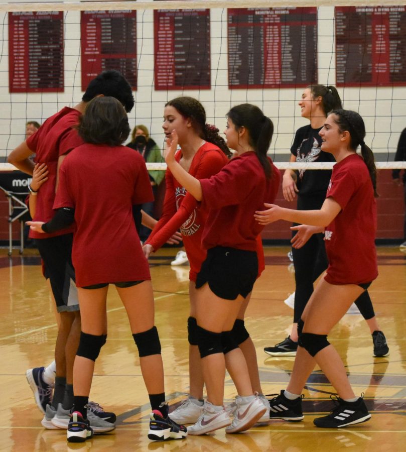 The student team huddles after the first set to determine positions. “There [are] a lot of people on the team, so we [used] that to our advantage,” senior Brandon Kilfeather said. “I thought it would be fun since [this is] my last year in high school, so it can’t hurt [to play].”