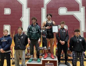 Senior Ilias Cholakis (third from right) stands on the first place podium in the 2022 King of the Rock Wrestling Tournament. 