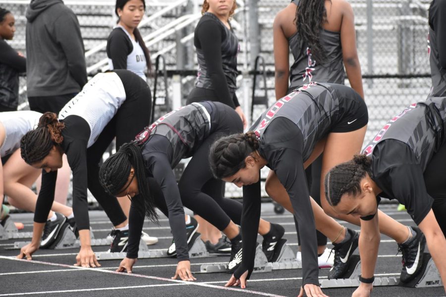 At Rock Ridge’s home meet on Jan. 4, sophomore Micah Younger, junior Alyssa Tucker, and sophomore Lilia Jones line up at the start line for the Girls 55m Dash. “[The most difficult thing about this season] is that I’m not at my best right now, but I’m going to get there in [outdoor track],” Younger said. 