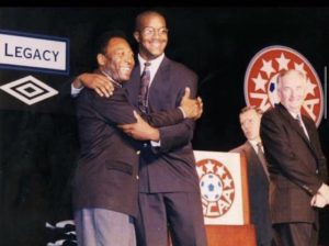 Coach Richard Gaskin hugs Pelé as he presents the All American award to him in Jan, 1998. The award is either earned by an athletic achievement at a championship event or by being selected by members of the national media, coaches association, or through a poll.