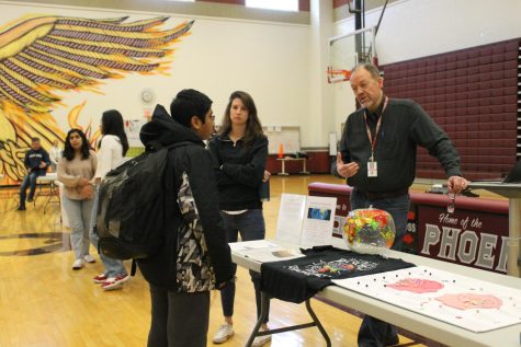 Social sciences teacher Kevin Briscoe presents to freshman Karthik Mittadhoddi the Advanced Placement (AP) Psychology class, an elective course that focuses on behavioral and mental processes of a person. 