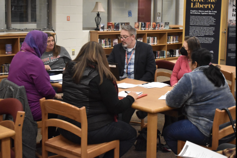 Sitting around a table, the PTSO, Student Activities and Engagement Coordinator Annamika Hacikyan, and Principal John Duellman convene to review and devise a plan to move forward from recent incidents.