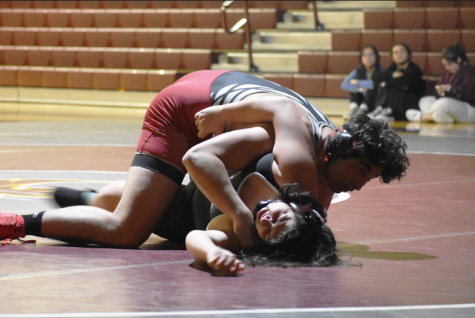 Ilias Cholakis attempts to pin down a struggling Spartan wrestler.