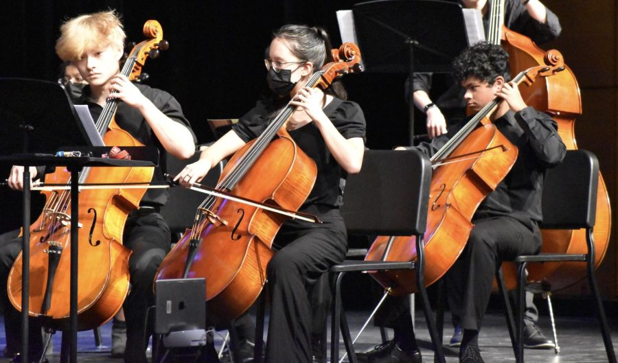 Cellists senior James Lee, senior Sydney Pascual, and freshman Shaun Sahayadarlin strum in tandem to the tune of the groups second piece, “Ad Astra,” arranged by Richard Meyer. At the actual assessment, the group will be scored from one to five. “One is the most superior rating, and we have, even with COVID, been scoring ones across everything,” Pascual said.