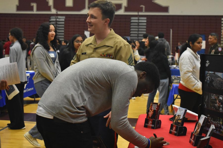 Expressing his interest in the Marines as a possible career, junior Emmanuel Bankole signs up for one of the various programs offered by their display. The Marines came to the job fair to provide students with multiple pathways with a fast-track to joining the Marines, like summer programs, the Marine Reserves, or scholarship opportunities.