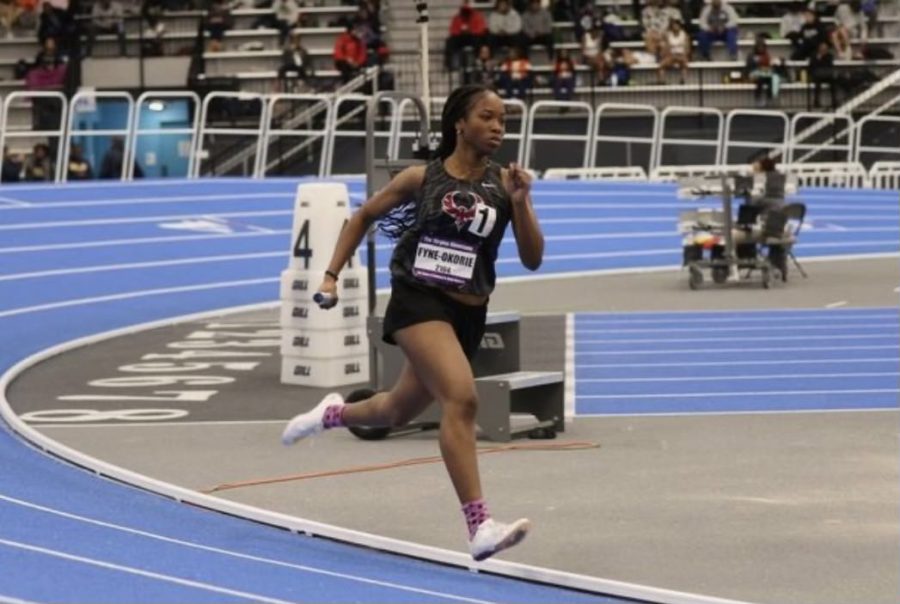 Freshman Zoe Fyne-Okorie sprints across the track, competing in the 4x200 relay race at the Virginia Beach regional showcase. 
