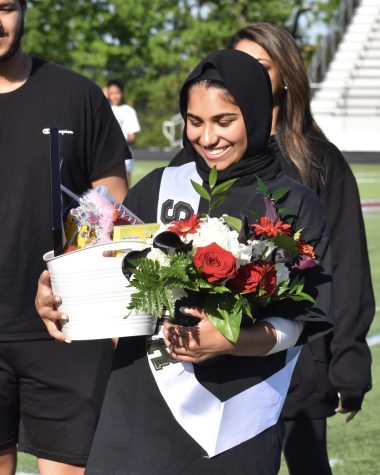 Senior Sarah Baig holds surprise gifts from her teammates as a celebration of her senior night.