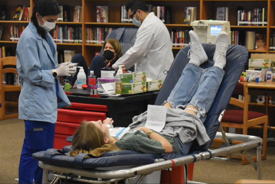 Senior Taylor Cheek sits upside down after feeling lightheaded due to donating blood. “Donating blood is something I’ve always found important. I’ve never had a bad experience donating blood, I just don’t want to see it.”