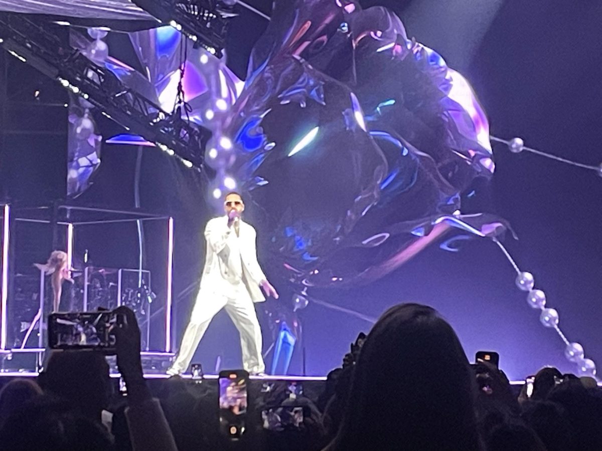 Maluma sings and dances on stage at the Capital One Arena in Washington, D.C., captivating fans with his voice. 

