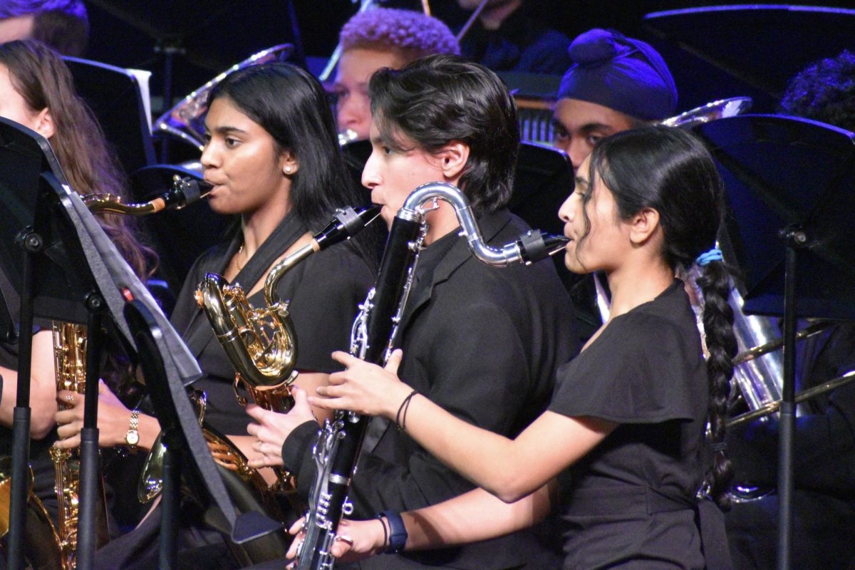 Junior Nivi Mohan, junior Tim Torres, and senior Tarini Panidepu (pictured left to right) play their respective instruments as part of the Wind Ensemble.